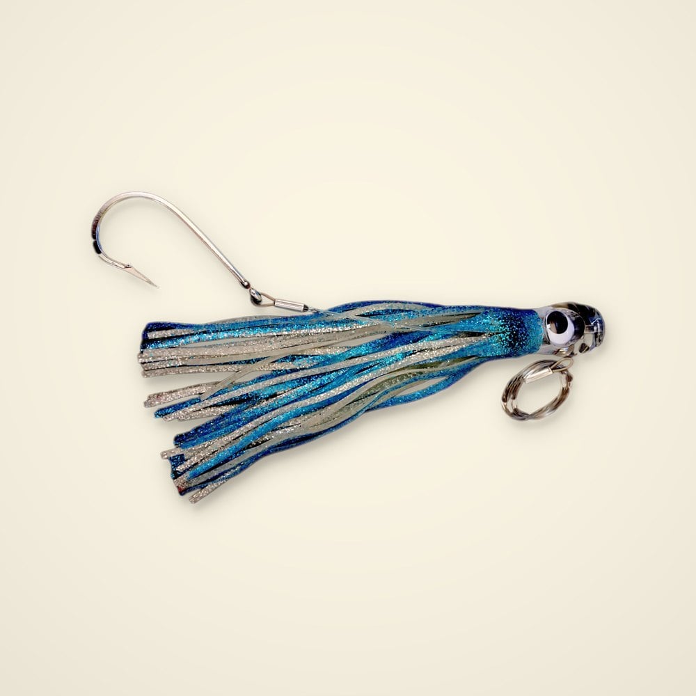 Rigged trolling skirt lure with a clear eyed head, electric blue and silver glitter skirt, stainless hook and leader