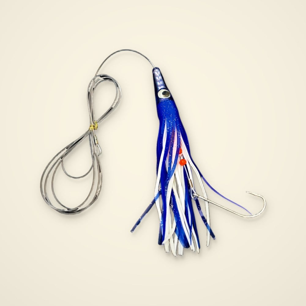 Blue and white trolling skirt lure with a holographic head, doll eye, orange beads, coiled mono leader and hook