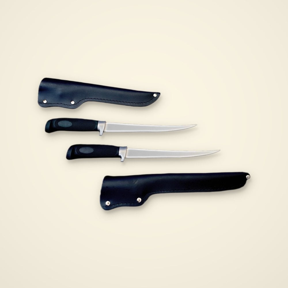 Two fillet knives with black textured handles and flexible steel blades beside two black sheaths