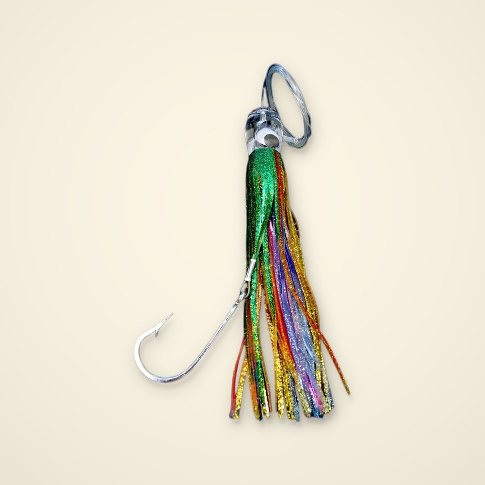 Rigged trolling skirt lure with green, gold, red and blue glitter strands, clear head, mono leader loop and large hook