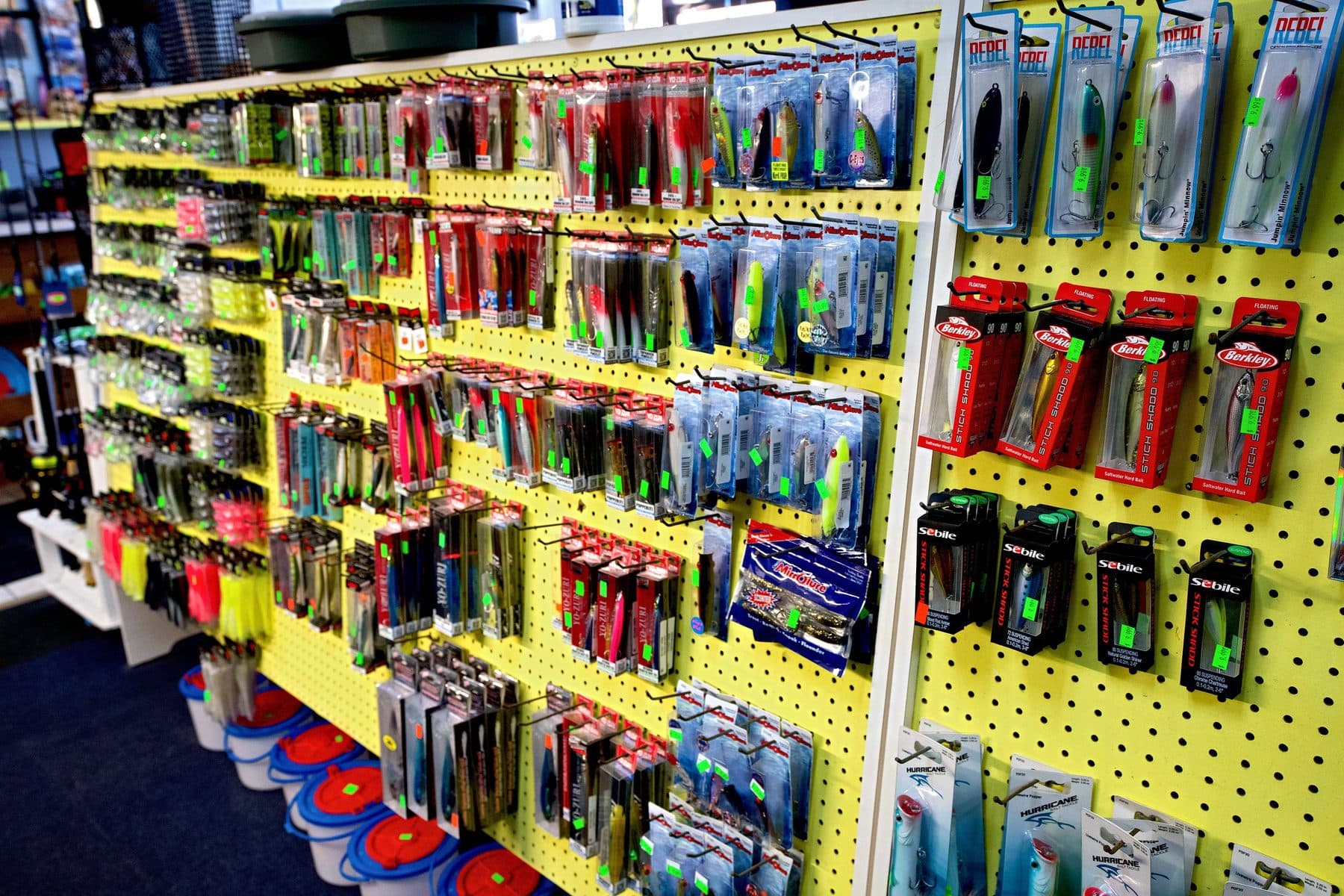 Pegboard of boxed hard baits including Rebel Jumpin' Minnows, Berkley Stick Shadd 90s, Sebile Stick Shadds and MirrOlures