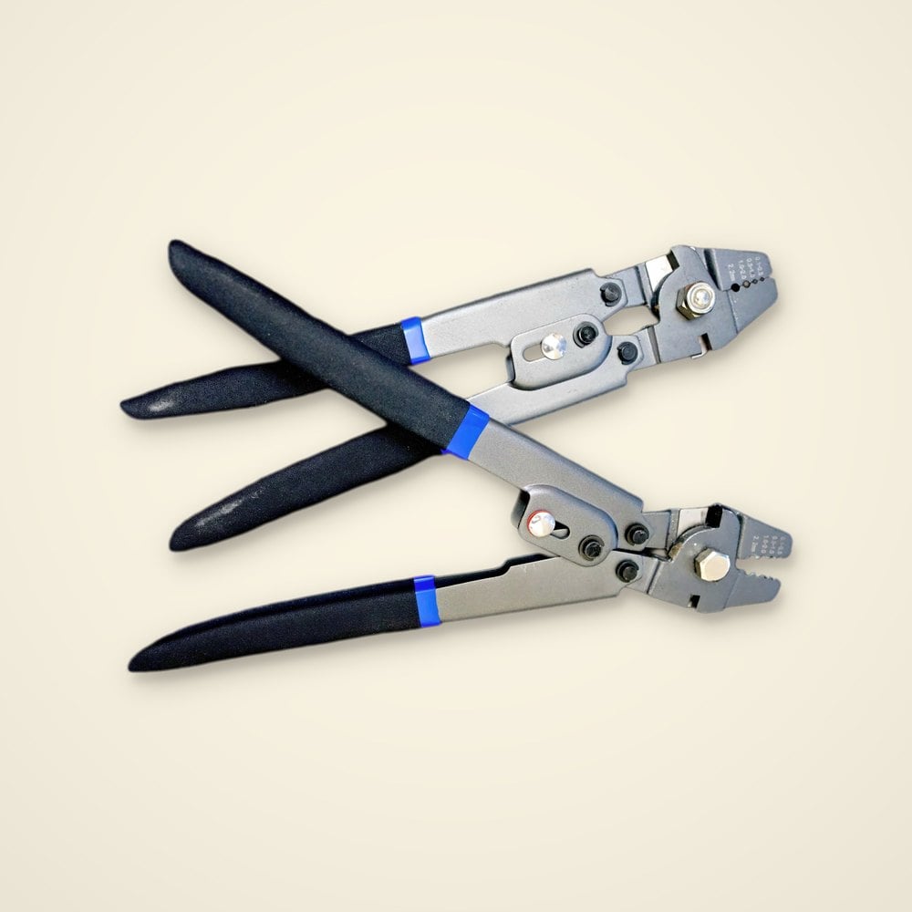 Two gray leader sleeve crimpers with black grips and blue bands, jaws stamped with die sizes 0.1 to 2.2mm