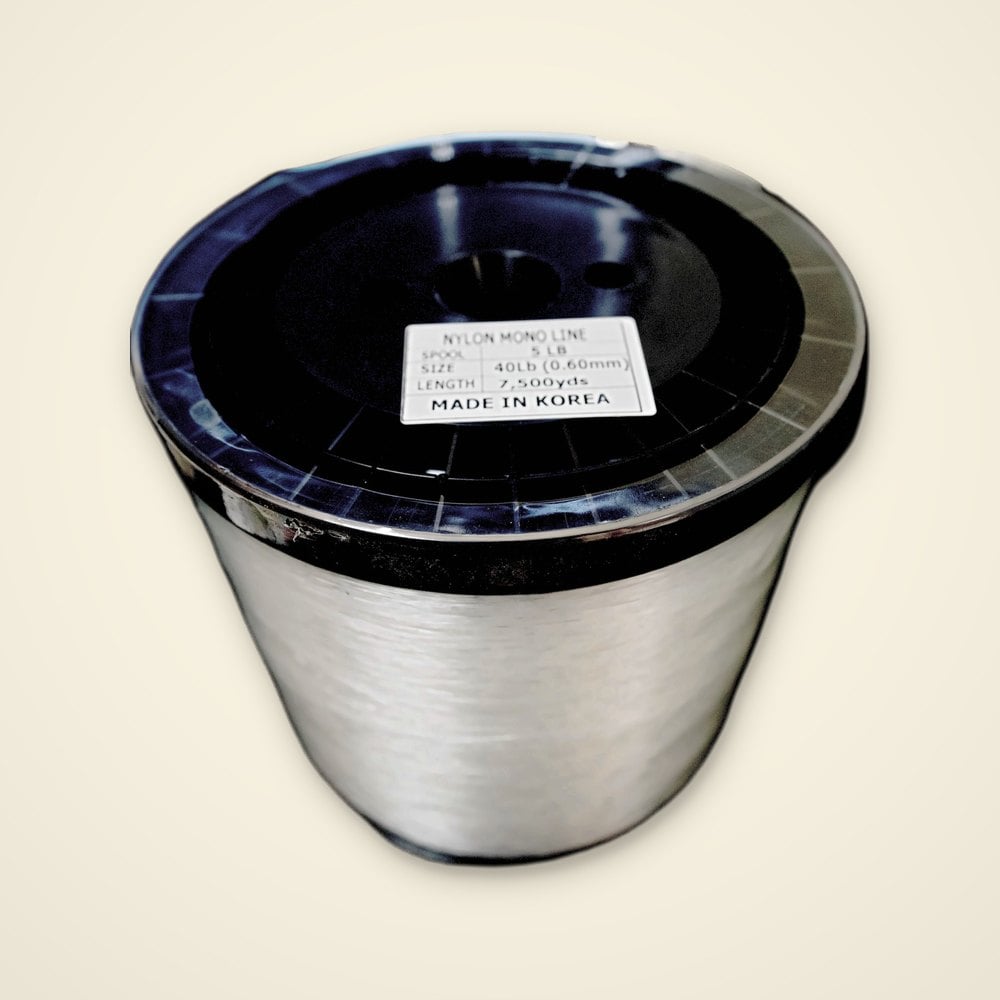 Bulk spool of clear 40 lb nylon mono fishing line, 7,500 yards, on a light background