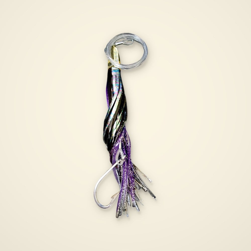 Purple and black rigged trolling skirt lure with an iridescent skirt, clear leader loop and stainless hook