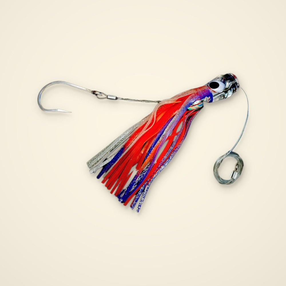 Rigged trolling skirt lure with a clear eyed head, red, purple and silver glitter skirt, stainless hook and leader coil