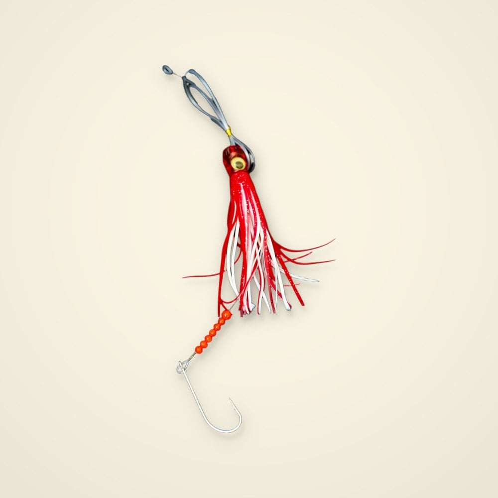 Red and white trolling skirt lure with a doll eye, mono leader loop, seven orange beads and a large hook