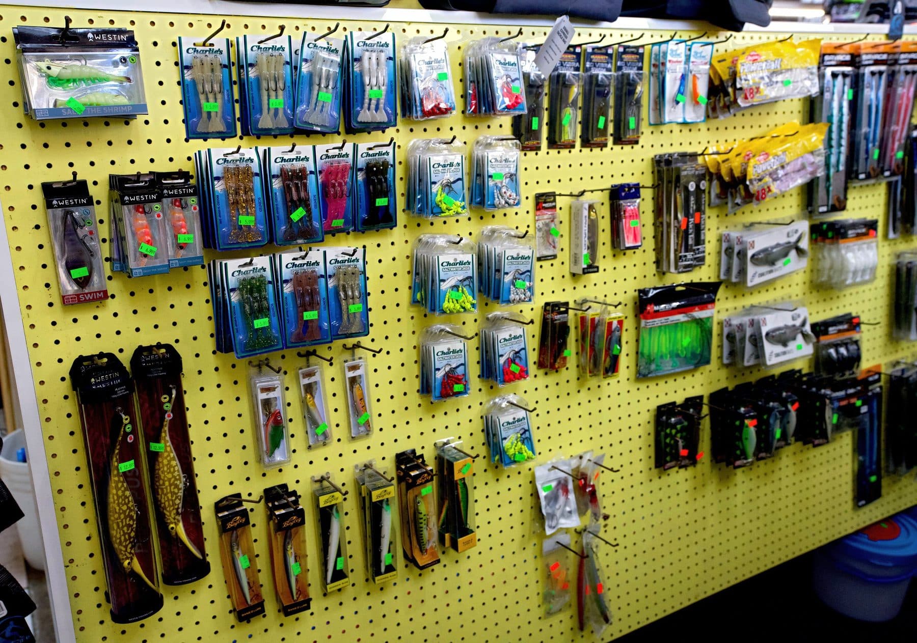 Pegboard of Westin Salty The Shrimp lures, Charlie's rigged soft shrimp packs, saltwater jig heads and boxed Bagley plugs