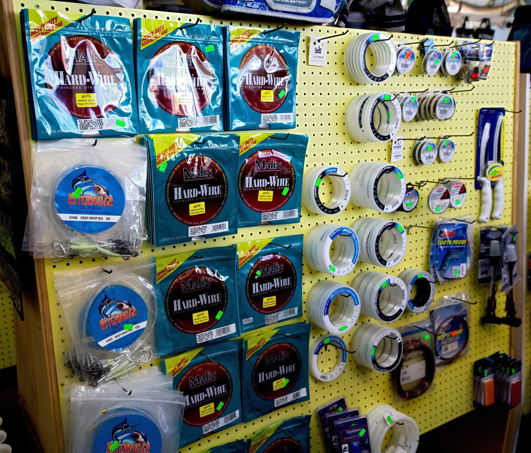 Pegboard endcap of Malin Hard-Wire leader packs, RiteAngler deep drop rigs and clear monofilament leader spools